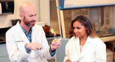 Faculty and student working in a biology lab